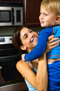 Mom lifting happy child.